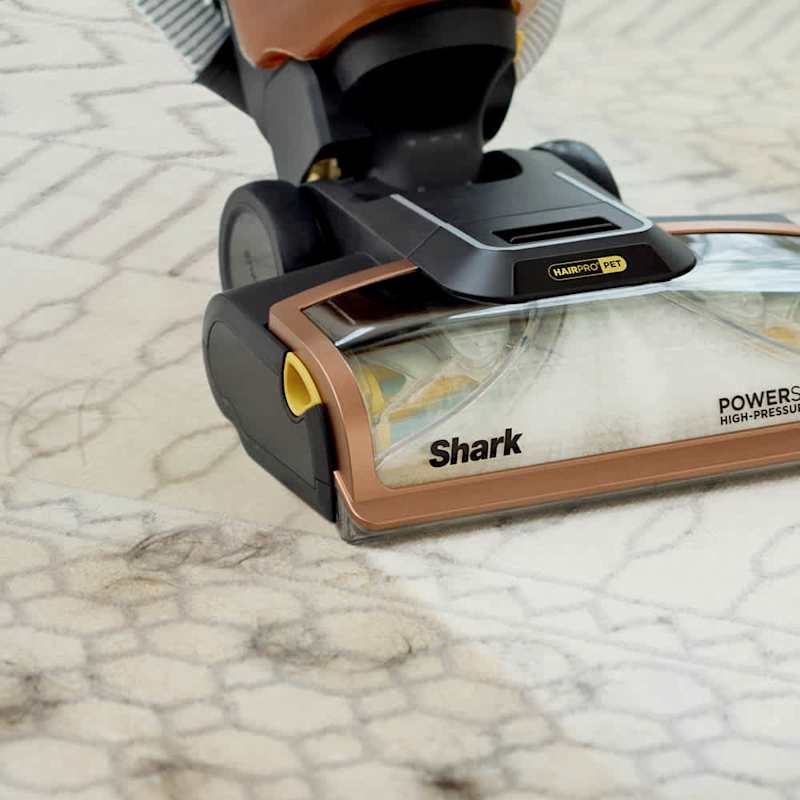 Close-up of the PowerSpray high-pressure nozzle and brushroll on carpet
