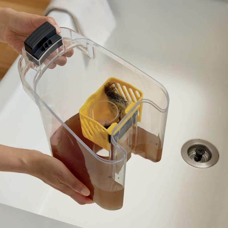 Emptying the dirty-water tank, showing trapped pet hair caught by the HairPro basket